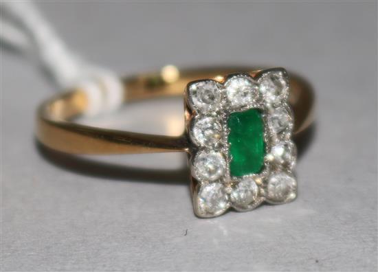 An 18ct gold emerald and diamond plaque ring